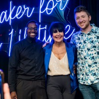 President Mantella takes a picture with two boys while someone is taking an iPhone picture.